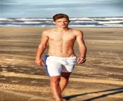 shirtless twink walks on the beach.jpg from 18 twinks in