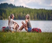 young female friends sitting ground lake hiking hills trip nature beautiful day 273058857.jpg from lake forest friends jpg free nudist piece pure beach family dark bgrade