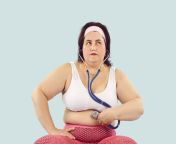 obese large chubby overweight woman sports clothes holds stethoscope skin big fat belly listens to bowel sounds 311919808.jpg from bbw inflata big fat obese