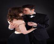 passionate man removing dress strap woman s shoulder young men isolated over black background 46851196.jpg from old man removing young dress very hot
