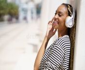 beautiful black girl listening to music wireless headphones outdoors 242225159.jpg from ebony listening