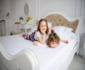 brother sister primary school age play pranks bed them very cheerful 90936940.jpg from brother sister share a bed to sleep