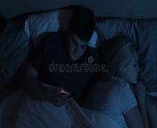 cheating husband couple issue infidelity betrayal disloyal man using mobile phone watching porn xxx film sex chat lying bed 211255216.jpg from bhabhi sleeping cheating the