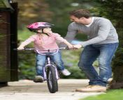 father teaching daughter to ride bike garden smiling 33074841.jpg from step daughter learning to ride c