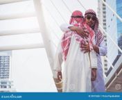 two arab businessmen greet hug city background two arab businessmen greet hug city 95975685.jpg from two arab