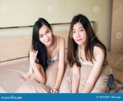 young asian lesbian women couple bed beautiful looking camera relaxing happy girl wake up smile together 108722588.jpg from asian lesbian