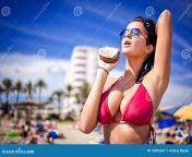 very hot young woman holding coconut beach 18095647.jpg from very myhotz