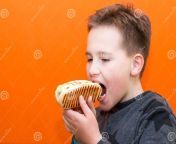 handsome yers old boy holding biting hot dog indoors orange studio background image closeup copy space body positive close up 220451879 jpgw992 from 10 yers xxxporn sexix house wife