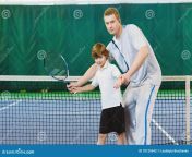 instructor coach teaching child how to play tennis court indoor 70129642.jpg from school teacher tennis