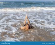 laughing woman sand under rising wave shore indian ocean island sri lanka 211641338.jpg from lankan tamil wife bathing and fuckeding 2 video