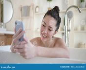 millennial girl bath mobile phone having webcam video conversation enjoy bodycare bathroom attractive young mixed 222560358.jpg from new webcam lady bath