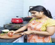 pretty indian young woman wearing apron cooking cutting vegetables domestic kitchen gas stove indian housewife 225978683.jpg from indian young house wife and hosband sex videos