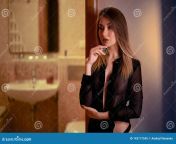 pretty young long haired girl translucent blouse poses t open door to bathroom hotel nice one hand near face 143177545.jpg from bathroom blouse open