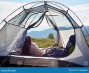 attractive naked woman camping back view attractive naked female traveller lying tent sleeping bag enjoying summer day 115019353.jpg from sleeping girlnude captured