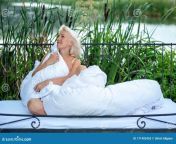 attractive young sexy blonde woman sitting bed sleeping nature front lake reeds bulrushes white duvet 171403455.jpg from very hot 18 sleeping mom local raped xxxwetha basu pras