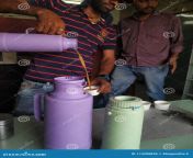 bangalore karnataka india feb indian milk seller adding milk to cup office milk person serving milk to people using 174288836.jpg from milk ladeো