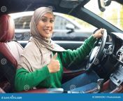 cheerful muslim woman driving car showing thumbs up great car i like portrait smiling muslim woman hijab gesturing thumbs 200829290.jpg from muslim grils car sexnty romence unc