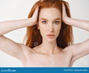 close up relaxed young redhead woman pale skin freckles massaging natural red hair standing naked make 212417231.jpg from young pale naked