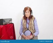 elderly lady listening to radio attentively headphones 54851121.jpg from granny hear