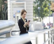 businesswoman checking cell phone outdoors westf22628.jpg from scenes from cell