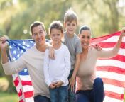 family of four holding an american flag.jpg from ami an family