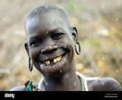 portrait of a surma tribe woman with enlarged lip and ears and toothy d0xt0n.jpg from surma