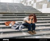 female college student crying after failing exam and sitting alone on granite steps 2af1xd2.jpg from college cry