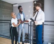 stock salesman in business casual with young couple on apartment balcony shaking hands adobestock317051577 copy.jpg from tenant s