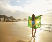 woman holding brazilian flag on copacabana beach rio brazil 492693455 597a51c3d088c00011a045a2.jpg from nude brasil