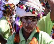 adivasi tribal man face decorated and wearing ornate decorated headgear to celebrate holi festival kavant gujarat india asia rhplf16071.jpg from gujarat adivasi