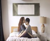 romantic lesbian kissing on girlfriends forehead royalty free image 1571951475.jpg from action on bed