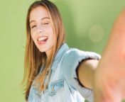 young woman winking sticking out her tongue taking selfie against green background 23 2148178147.jpg from young selfie twens