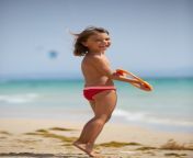 young girl happy with frisbee beach 422213 399.jpg from beach young