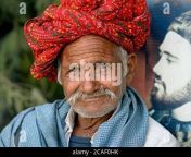 old indian rajasthani man with moustache wears a colourful rajasthani turban pagari and looks at the camera 2caf0hk.jpg from rajasthani saxi vido गाँव की लडकी की