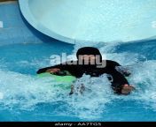 muslim woman wearing hijab descends from water chute veega land amusement aa7tg5.jpg from veegaland hot swimming pool
