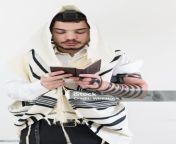 young orthodox jewish man in shawl and phylacteries praying with a prayer book jpgs1024x1024wisk20cq9b7bvq8fyspws0rqh385n5aetjb1lvaqfykbjebhb0 from ped judeu