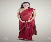 126899891 full length of young indian woman wearing a red saree and smiling at the camera shot in the studio.jpg from indian wife cam shot full