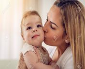 93280000 beautiful young mom having fun with her cute baby boy at the home she is kissing baby.jpg from funny cute mom kiss
