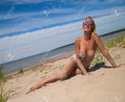116852024 young woman with big on a sandy beach.jpg from beach tits