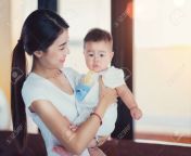 122598946 thai mother and her baby with home background this immage can use for baby mom and family concept.jpg from thailand mom