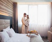 123404747 young happy couple in hotel room in the morning just married man and woman standing at window.jpg from hidden married couple hotel in room hidden sex