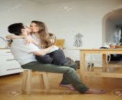 93438527 man kisses woman sitting on his legs in the kitchen.jpg from sit on his leg