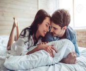 93049314 beautiful young couple in bedroom is lying on bed enjoying spending time together.jpg from young couple enjoyed