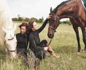 two young beautiful girls in gear for riding near their horses they love animals photo.jpg from beautiful riding 2