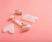gua sha massage tool made of natural pink quartz roller jade stone and oil on a pink background for face and body care part of traditional chinese medicine photo.jpg from china full body oil massag and sex xxx