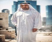 rich arab businessman in traditional white outfit in big city in background generative ai photo.jpg from arab bige