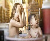 the older sister and brother were happily taking bath plastic tub in the morning take a shower outside on a hot day siblings are happy to play in the water children having fun playing in the water photo.jpg from bath with small brother hot wife 2