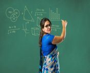 64b022a794359f0693c898fe portrait indian lady teacher saree stands against green white blackboard.jpg from indian classroom