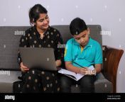 coronavirus outbreak and education concept lockdown and school closures indian mother helping son studying online classes at home covid 19 2cgk69b.jpg from india mom xx