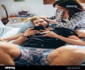 young beautiful woman stroking hair of bearded man while he is using tablet love relationship tenderness concept 2aa2yrg.jpg from beautiful stroking he